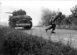 Un tanque ligero M5A1 del Ejército de los Estados Unidos protegido en el frontal con sacos terreros y equipado con cuchillas para atravesar setos en Normandía, principios de julio de 1944.